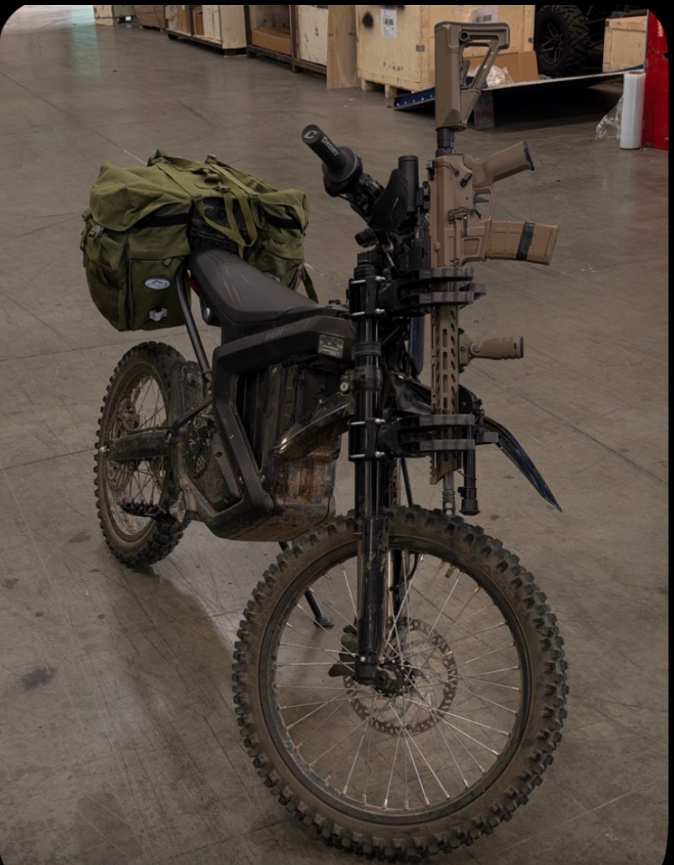 Outlaw-outfitted e-bike in a dark warehouse, built tough for real-world use